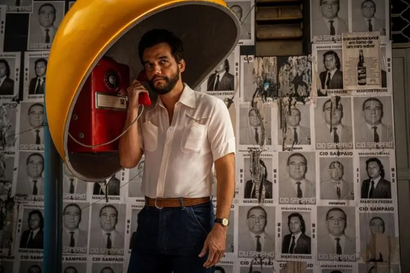 Rapaz falando no telefone antigo Orelhão de rua
